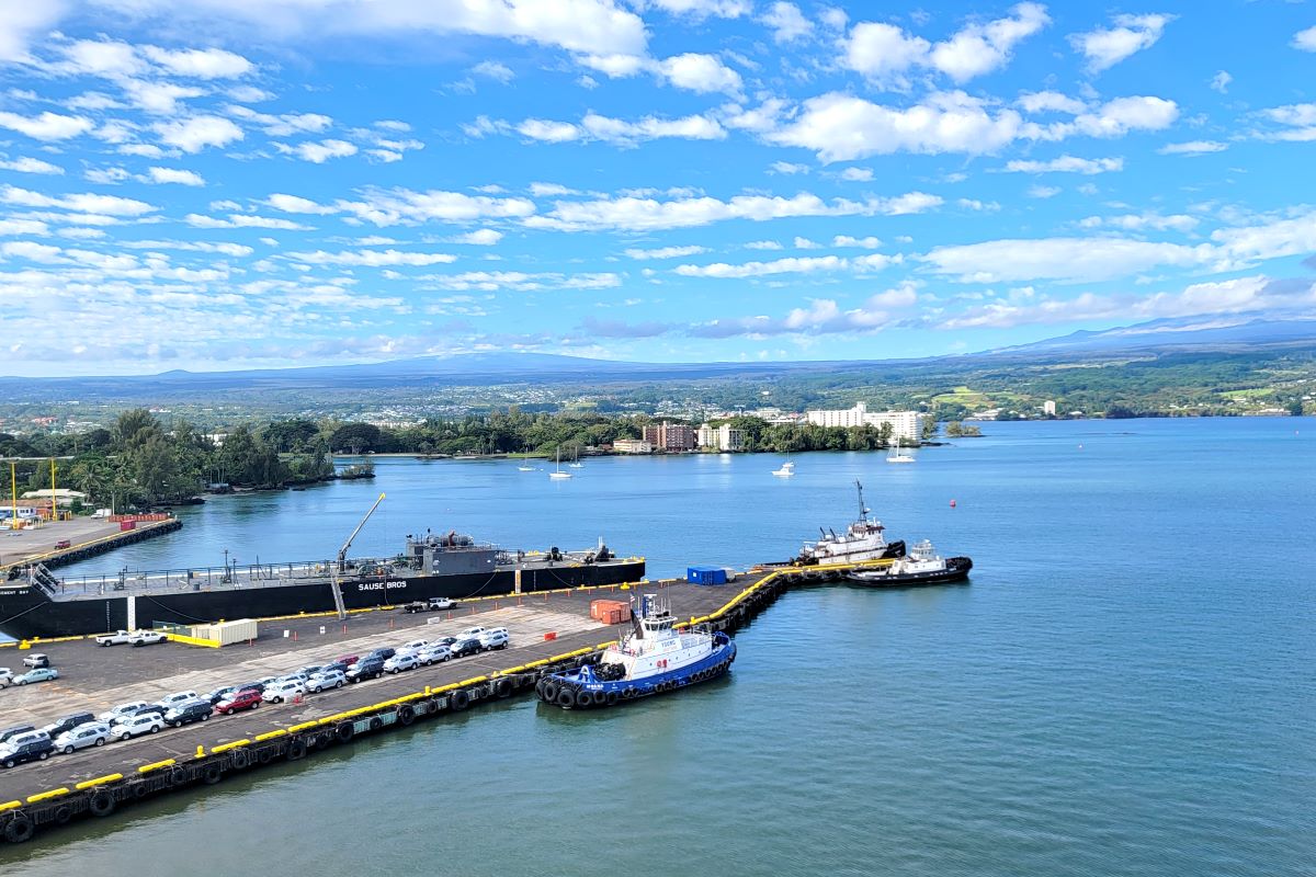 Hilo Harbour on the Big Island seen from the ship, with tugs at the quay and Mauna Kea beyond