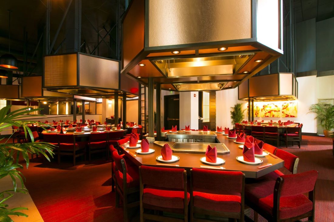The teppanyaki dining room at Tanaka of Tokyo, with griddle tables set for dinner