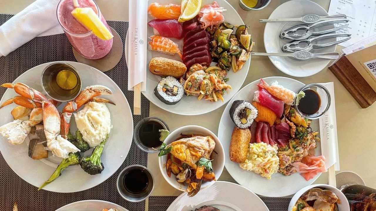 Plates of sushi, sashimi, poke and snow crab from the seafood buffet at Plumeria Beach House